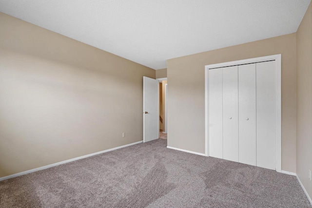 unfurnished bedroom with carpet flooring and a closet