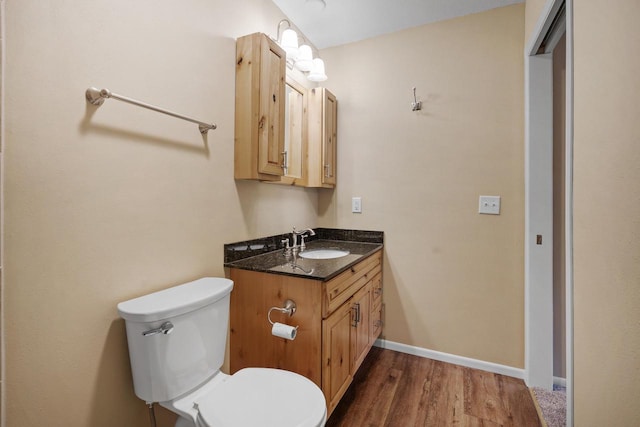 bathroom featuring vanity, hardwood / wood-style floors, and toilet