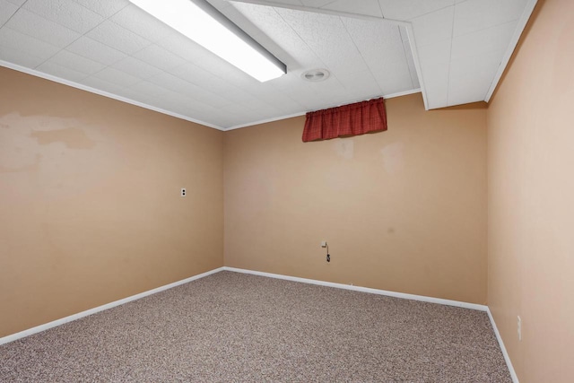 spare room featuring ornamental molding and carpet