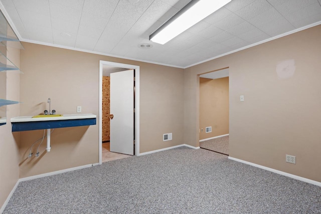 spare room with crown molding and light carpet