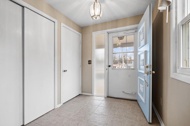 doorway with light tile patterned floors