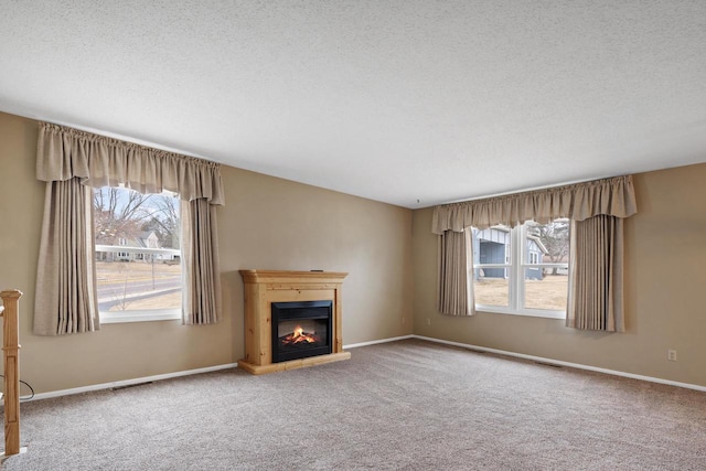 unfurnished living room featuring carpet floors and a textured ceiling