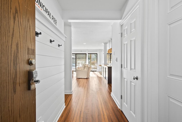 hall with wood-type flooring