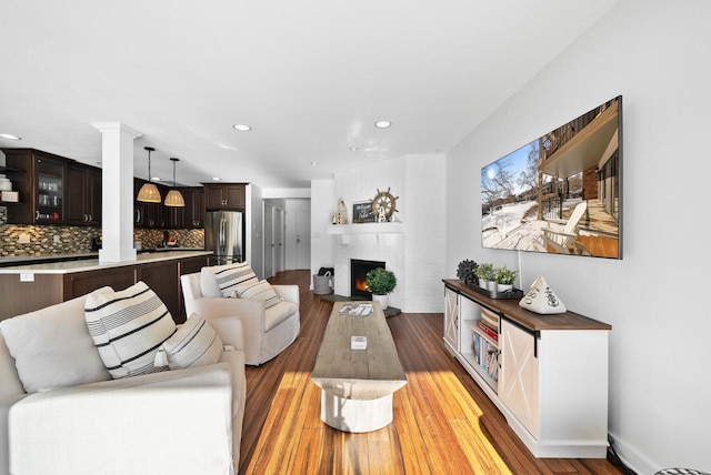 living room with wood-type flooring and a fireplace