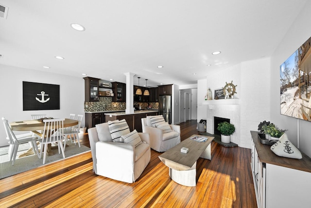 living room featuring a fireplace and dark hardwood / wood-style floors