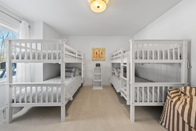 bedroom with carpet flooring and vaulted ceiling