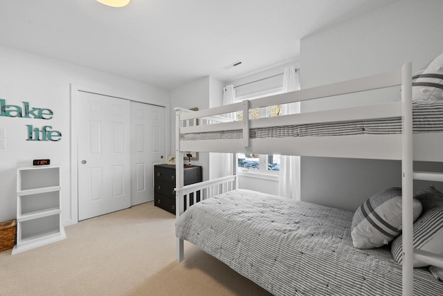 carpeted bedroom featuring a closet