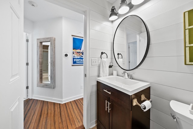 bathroom with vanity, hardwood / wood-style floors, and toilet