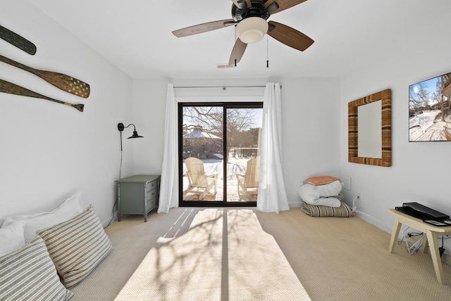 living area with ceiling fan and light colored carpet