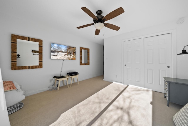 bedroom with light carpet, a closet, and ceiling fan