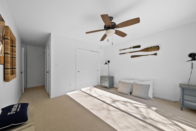 interior space with ceiling fan and a closet