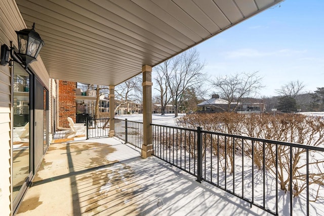 view of snow covered back of property