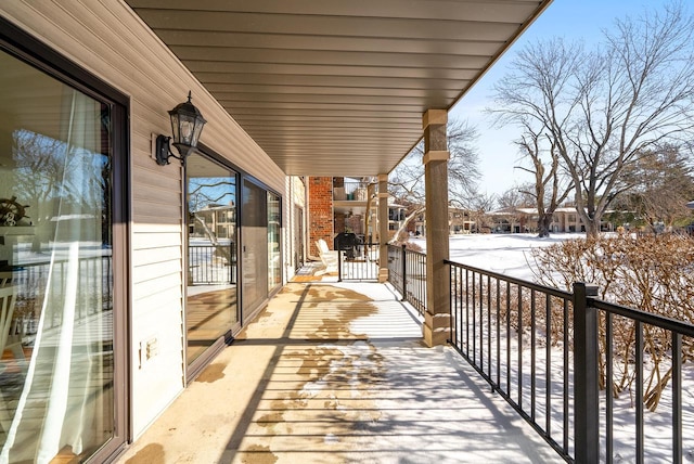 view of snow covered back of property