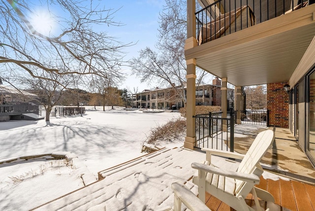 yard layered in snow featuring a porch