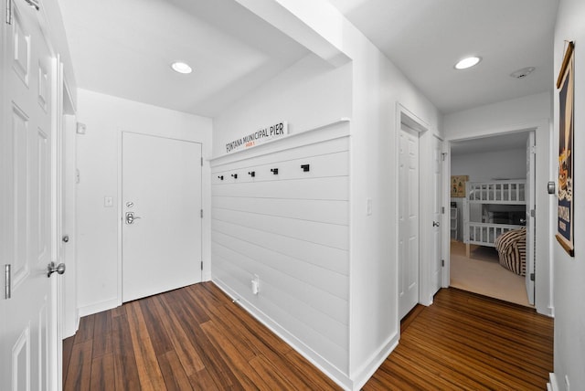 corridor with dark hardwood / wood-style flooring