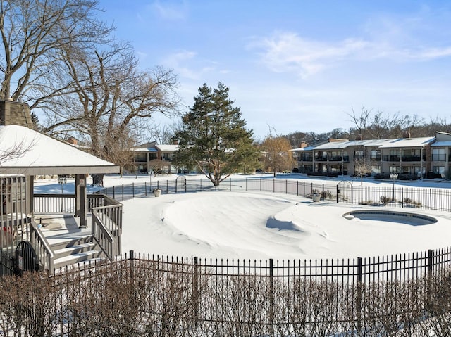 snow covered pool featuring a gazebo and a hot tub