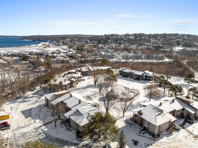 snowy aerial view with a water view