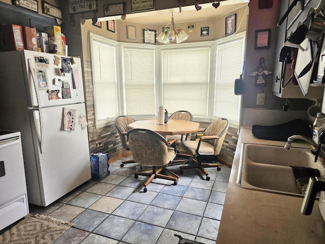 tiled dining area featuring sink and a wealth of natural light