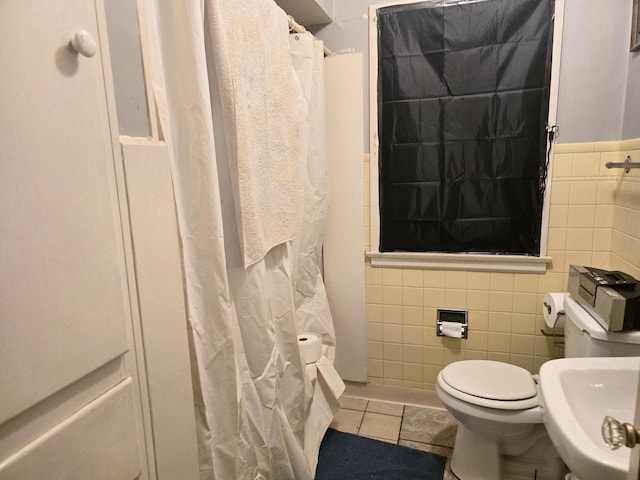 bathroom with sink, tile walls, tile patterned flooring, toilet, and a shower with shower curtain