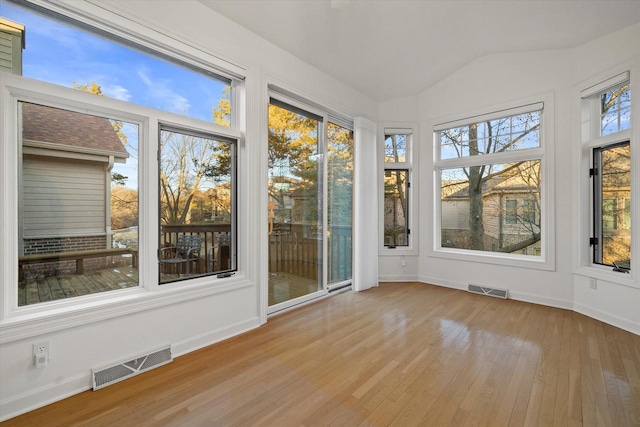 unfurnished sunroom with lofted ceiling