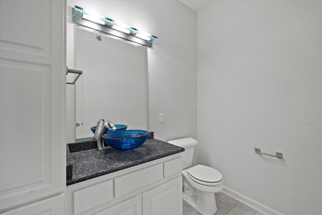 bathroom with vanity, tile patterned floors, and toilet