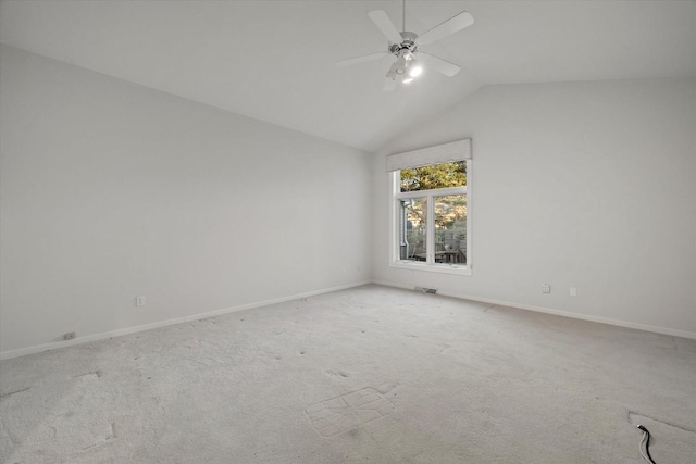 carpeted empty room featuring vaulted ceiling and ceiling fan