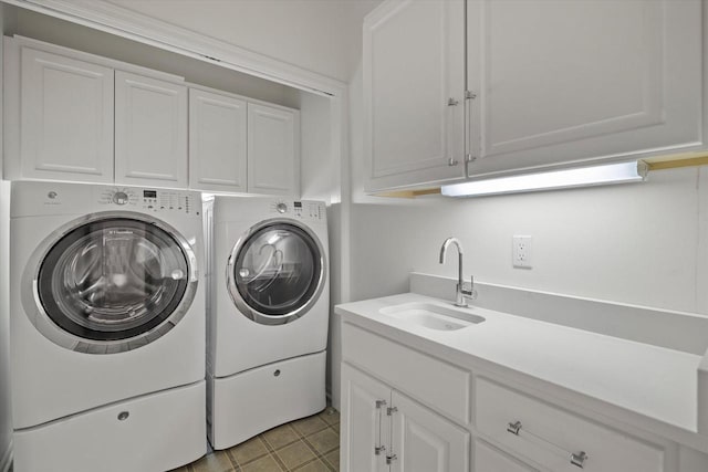 washroom featuring sink, cabinets, and washer and dryer