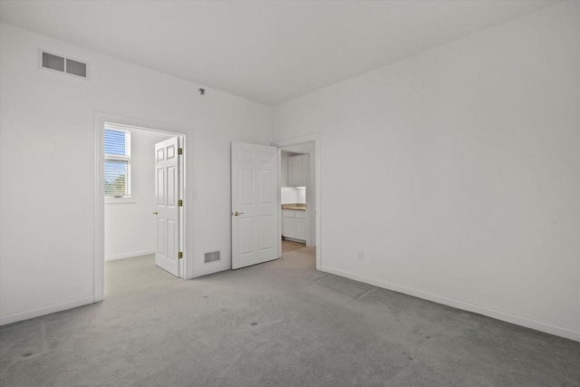 unfurnished bedroom with light colored carpet