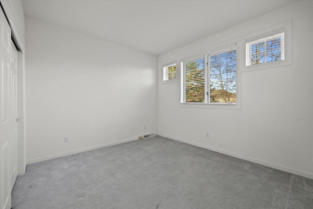 empty room featuring light colored carpet