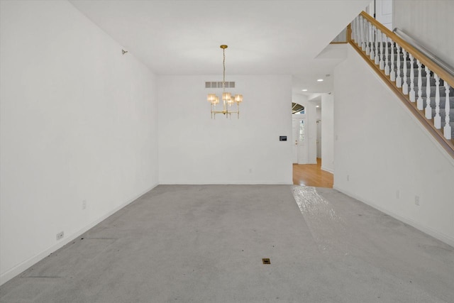 spare room with a notable chandelier