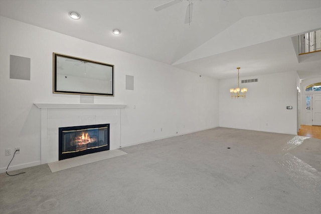 unfurnished living room with lofted ceiling and ceiling fan with notable chandelier