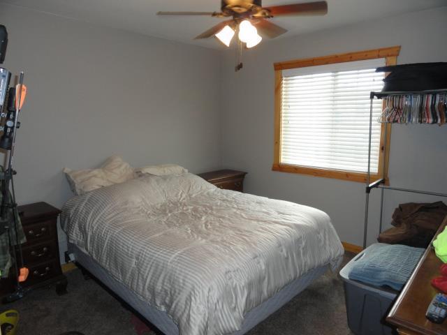 N8621 5th Rd, Westfield, WI 53964 - bedroom with ceiling fan and dark colored carpet