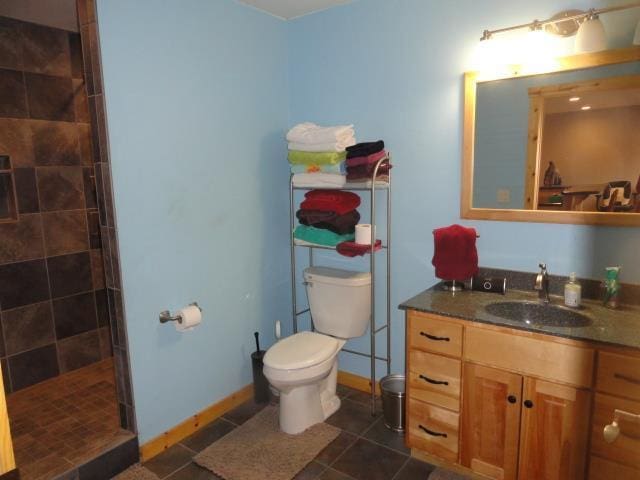 N8621 5th Rd, Westfield, WI 53964 - bathroom with vanity, a tile shower, tile patterned floors, and toilet
