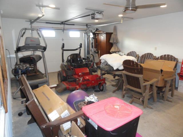 N8621 5th Rd, Westfield, WI 53964 - garage featuring ceiling fan and a garage door opener
