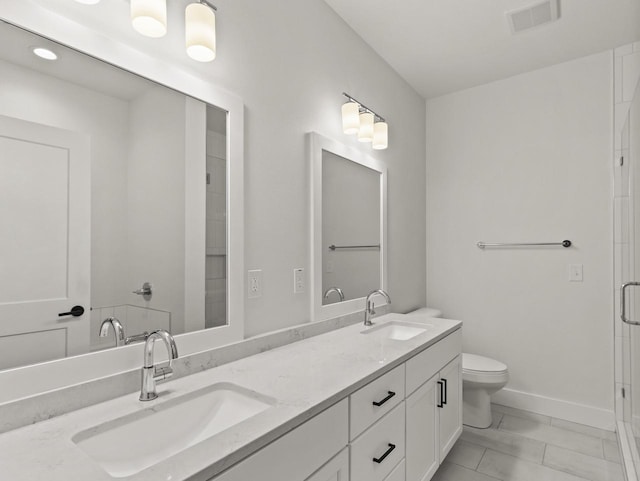 bathroom featuring vanity, an enclosed shower, and toilet