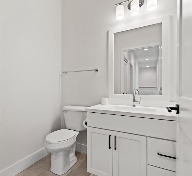 bathroom featuring tile patterned flooring, vanity, and toilet