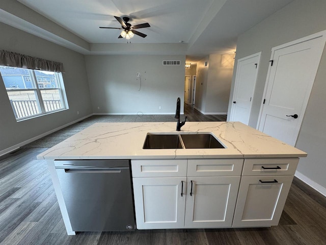 kitchen with sink, dishwasher, white cabinetry, light stone countertops, and a raised ceiling