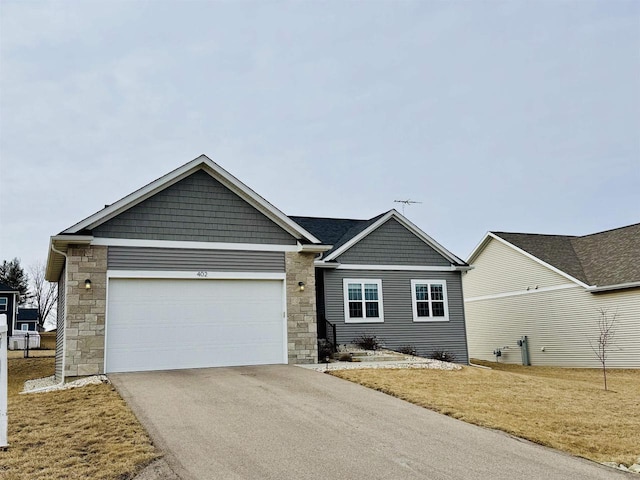 view of front facade with a garage and a front yard