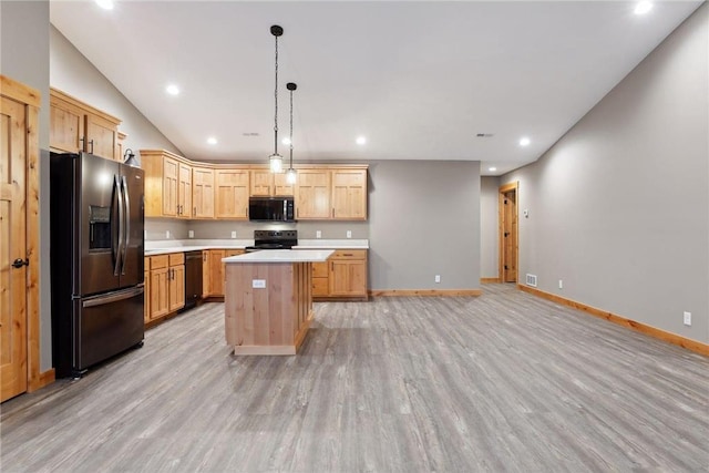 kitchen featuring pendant lighting, stainless steel fridge, light hardwood / wood-style flooring, electric range, and a kitchen island