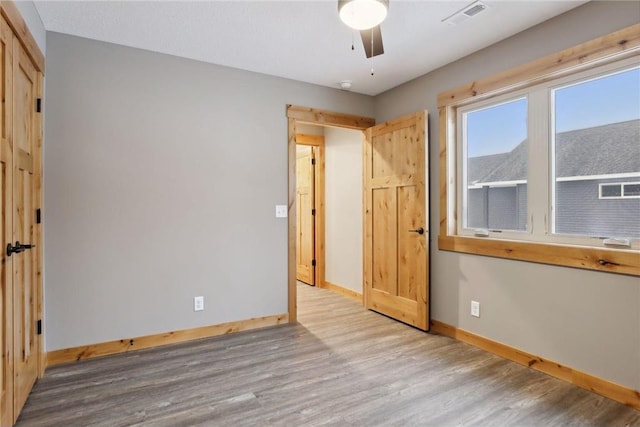 unfurnished bedroom with light wood-type flooring and ceiling fan