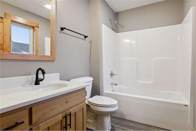 full bathroom with vanity, wood-type flooring, toilet, and shower / bath combination