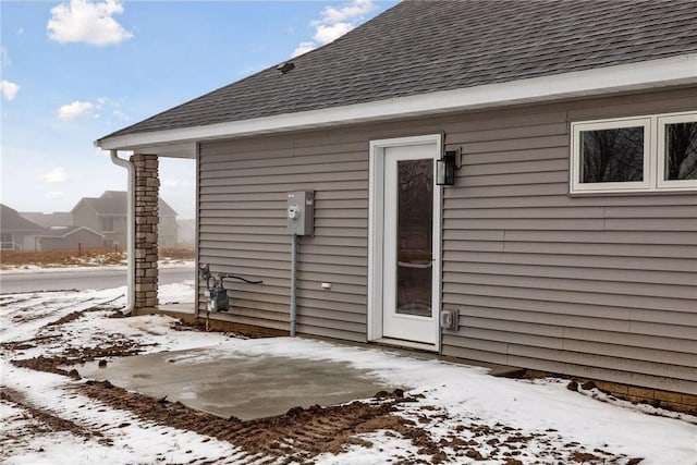 view of snow covered property entrance