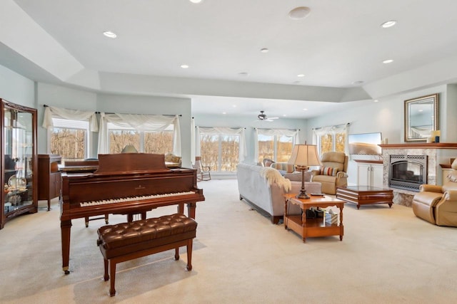 living area featuring a high end fireplace, light carpet, and recessed lighting