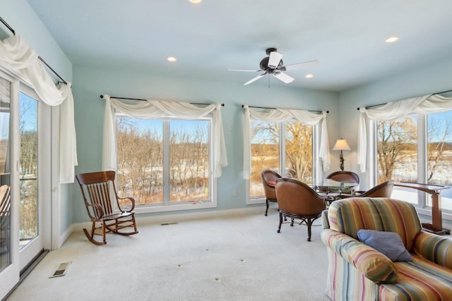 sitting room with recessed lighting, light colored carpet, and plenty of natural light