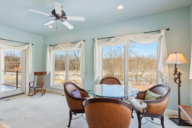 interior space featuring a ceiling fan, recessed lighting, visible vents, and light colored carpet