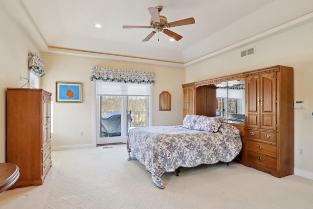 bedroom with ceiling fan, baseboards, visible vents, and a raised ceiling