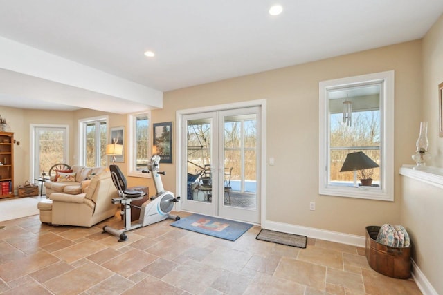 exercise room featuring recessed lighting, french doors, stone finish flooring, and baseboards