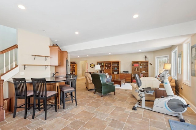 interior space featuring stairs, stone finish floor, baseboards, and recessed lighting