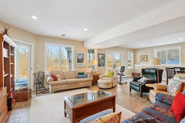 living room featuring a wealth of natural light, recessed lighting, french doors, and baseboards