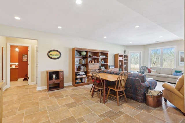 living area featuring baseboards and recessed lighting